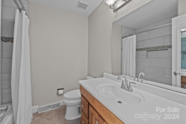 full bathroom with tile patterned floors, a textured ceiling, vanity, shower / bathtub combination with curtain, and toilet