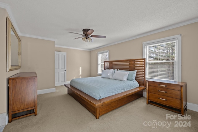 carpeted bedroom with multiple windows, a textured ceiling, ceiling fan, and ornamental molding