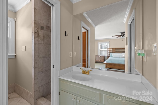 bathroom featuring ceiling fan, tile patterned floors, a textured ceiling, vanity, and ornamental molding