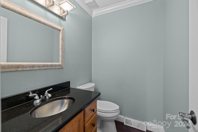 bathroom with vanity, hardwood / wood-style flooring, toilet, and crown molding