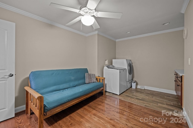 sitting room with washer and clothes dryer, ceiling fan, wood-type flooring, and ornamental molding