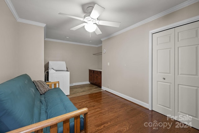 living area featuring washer / dryer, dark hardwood / wood-style floors, ceiling fan, and ornamental molding