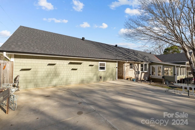 back of house with a patio area and a sunroom