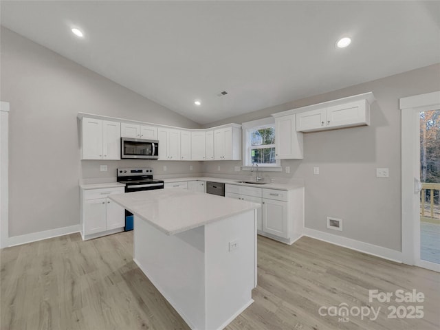 kitchen featuring white cabinets, a center island, and appliances with stainless steel finishes