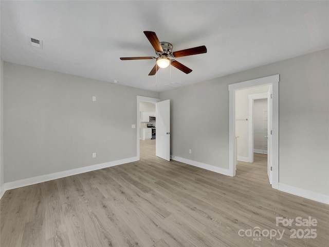 empty room with ceiling fan and light wood-type flooring