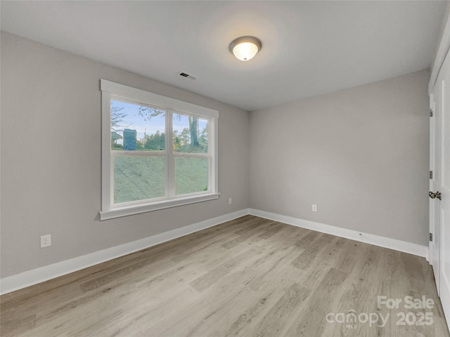 spare room with light hardwood / wood-style floors