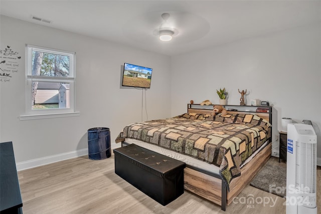 bedroom with ceiling fan and light hardwood / wood-style flooring