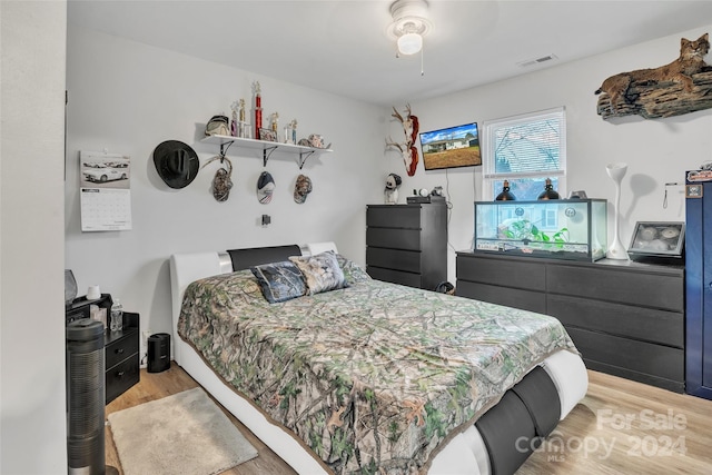 bedroom with ceiling fan and light hardwood / wood-style flooring