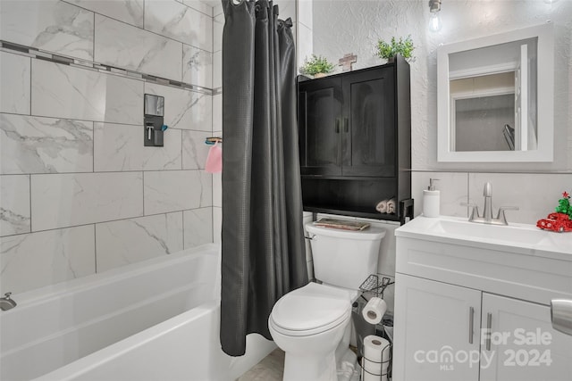 full bathroom featuring shower / bath combo, vanity, and toilet