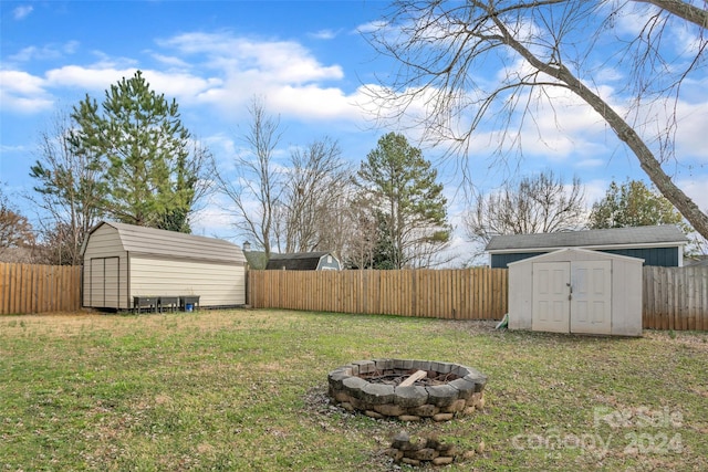 view of yard with a fire pit and a storage unit