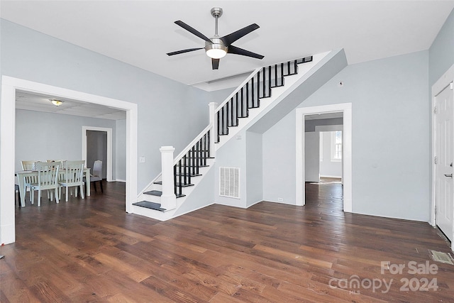 stairs featuring ceiling fan and wood-type flooring