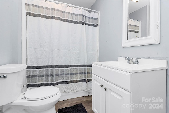 bathroom with vanity, toilet, wood-type flooring, and walk in shower