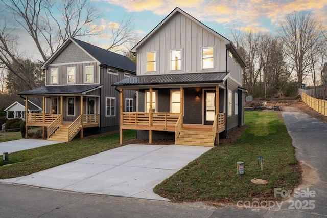 view of front of property featuring a lawn and a porch