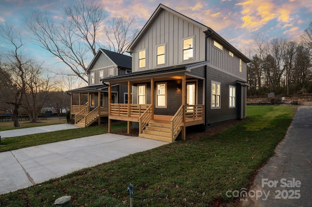 view of front of house with a lawn and covered porch