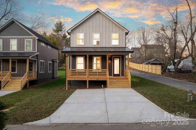 view of front of property with a yard and a porch