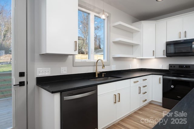 kitchen featuring appliances with stainless steel finishes, white cabinetry, and sink