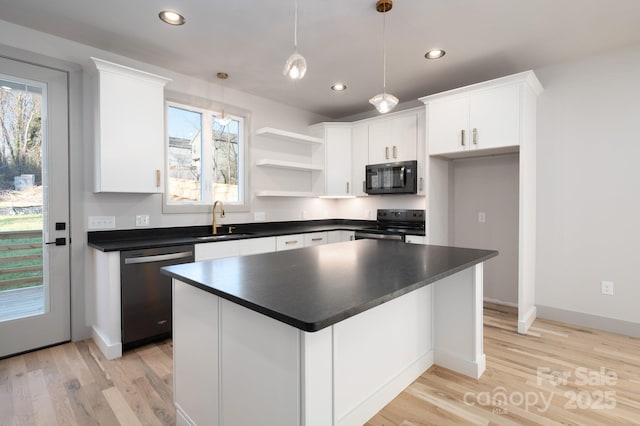 kitchen with stainless steel appliances, sink, white cabinets, a kitchen island, and hanging light fixtures