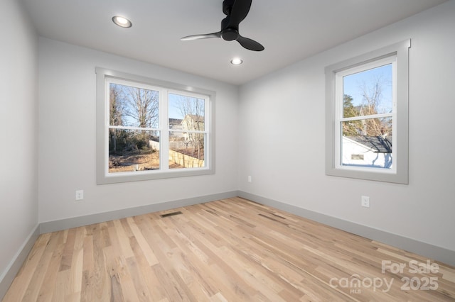 unfurnished room with light hardwood / wood-style flooring and ceiling fan