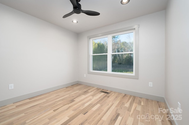 unfurnished room featuring ceiling fan and light hardwood / wood-style flooring