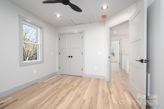 unfurnished bedroom with ceiling fan, light hardwood / wood-style floors, and a closet