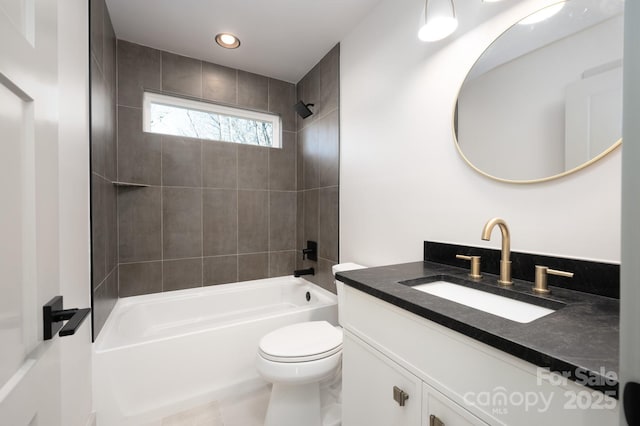 full bathroom featuring tile patterned floors, vanity, tiled shower / bath combo, and toilet