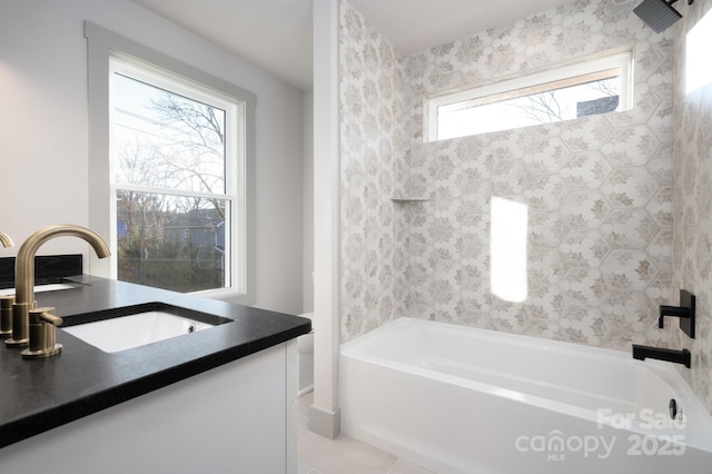 bathroom with tile patterned floors, vanity, and a healthy amount of sunlight