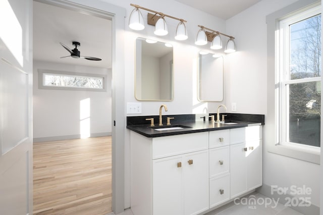 bathroom with wood-type flooring, vanity, plenty of natural light, and ceiling fan