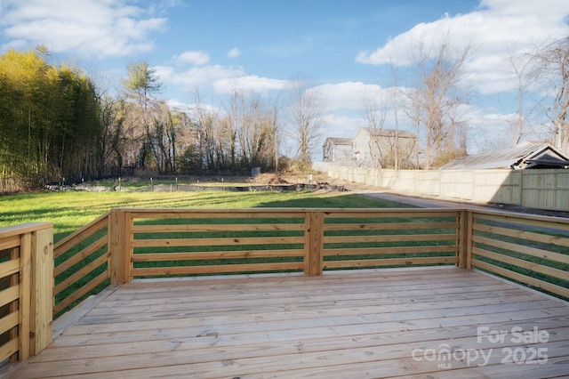 wooden deck featuring a yard