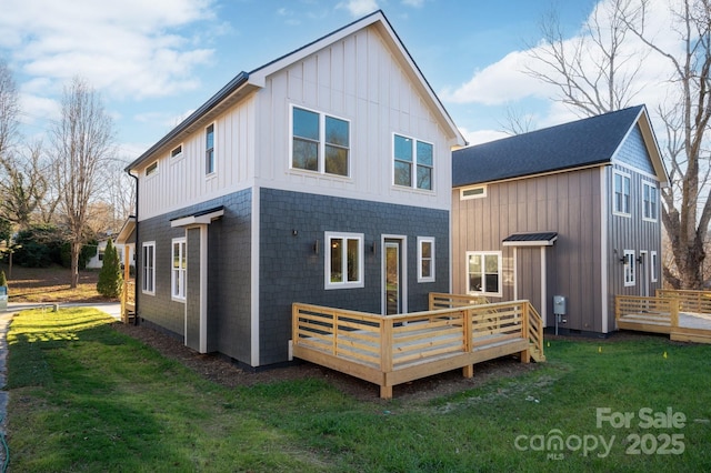 back of house featuring a deck and a yard