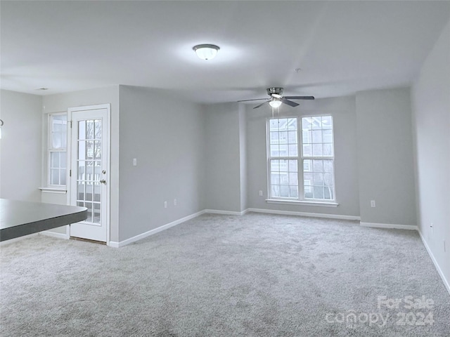 carpeted empty room featuring ceiling fan