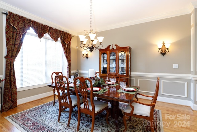 dining area with hardwood / wood-style floors, a healthy amount of sunlight, and ornamental molding