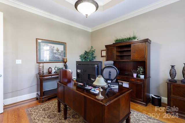 home office with light hardwood / wood-style flooring and ornamental molding