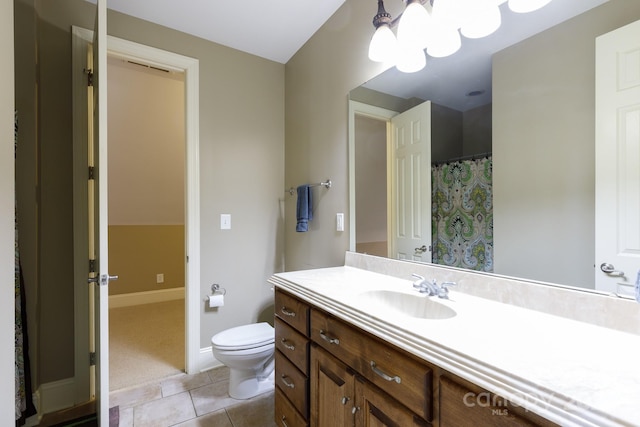 bathroom with tile patterned flooring, vanity, and toilet