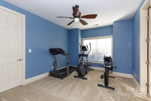 workout area featuring light carpet and ceiling fan