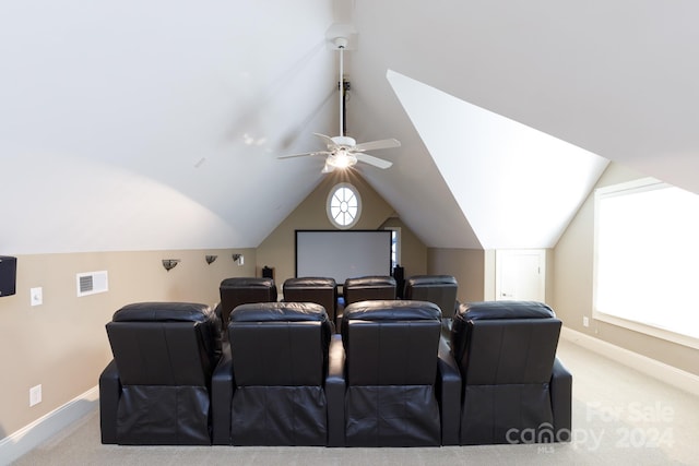 carpeted home theater featuring vaulted ceiling, plenty of natural light, and ceiling fan