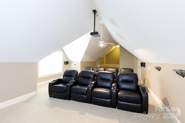 carpeted cinema room with vaulted ceiling and ceiling fan