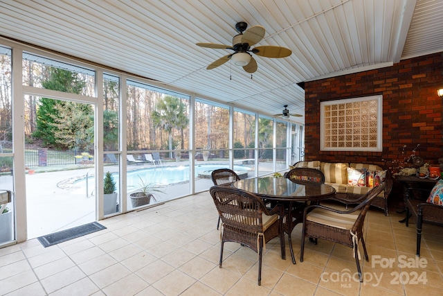 sunroom featuring ceiling fan, a healthy amount of sunlight, and wooden ceiling