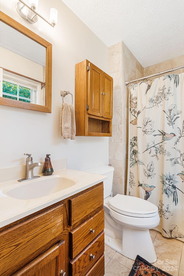 bathroom featuring a shower with curtain, tile patterned flooring, a textured ceiling, toilet, and vanity