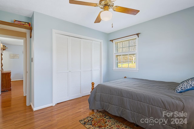 bedroom with ceiling fan, a closet, and light hardwood / wood-style flooring