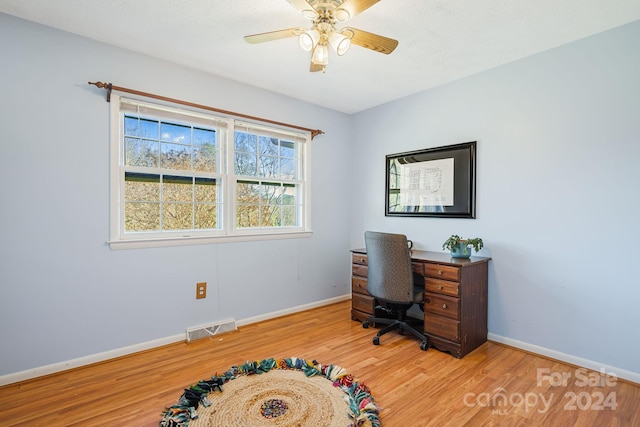 office space with light hardwood / wood-style floors and ceiling fan