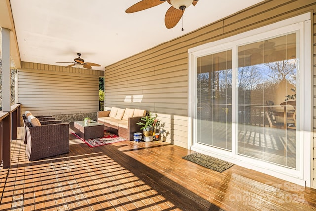 wooden terrace featuring ceiling fan and an outdoor hangout area