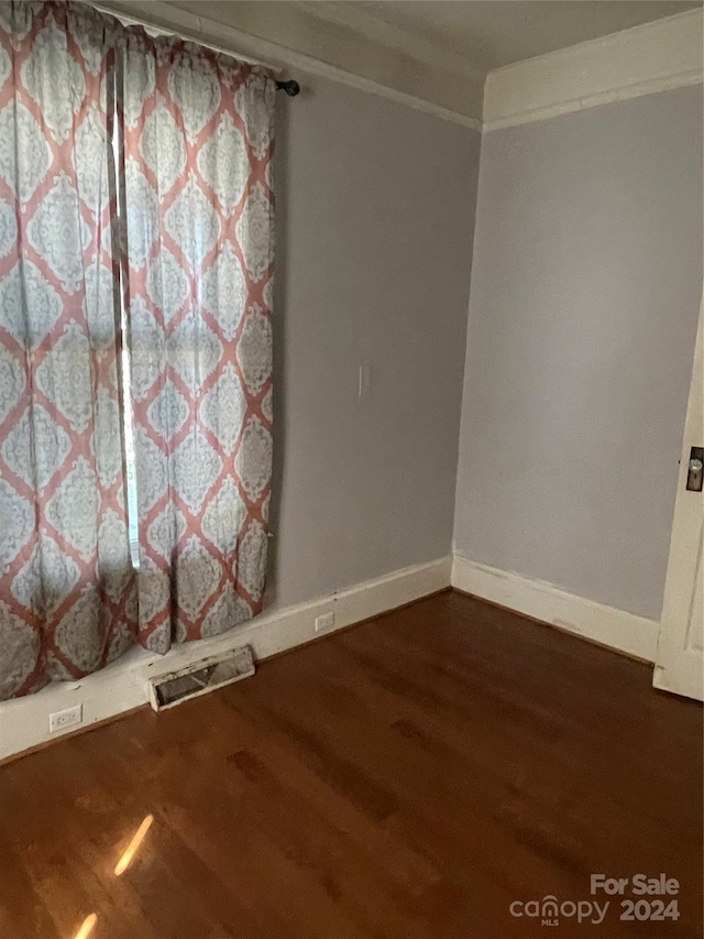 unfurnished room featuring hardwood / wood-style flooring