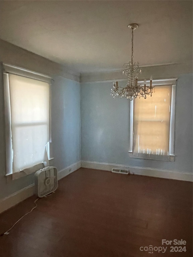 empty room with a notable chandelier