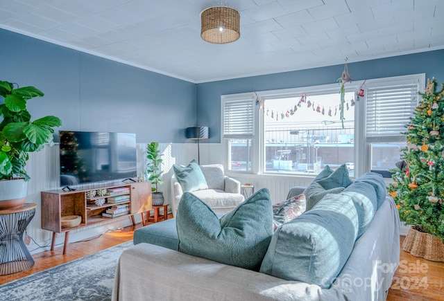 living room featuring hardwood / wood-style floors and crown molding