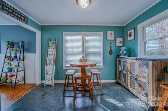 dining space with dark wood-type flooring and ornamental molding