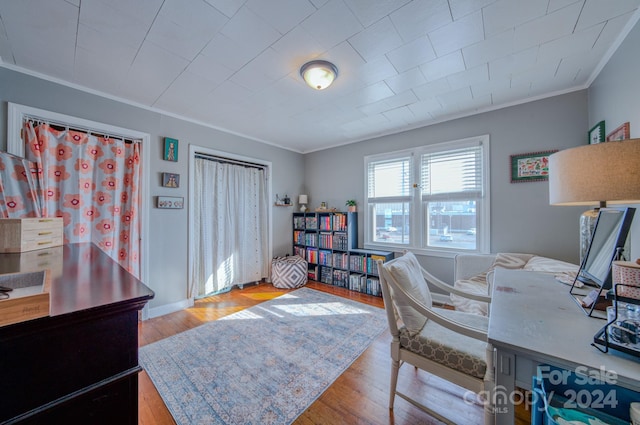 office space with crown molding and light hardwood / wood-style floors