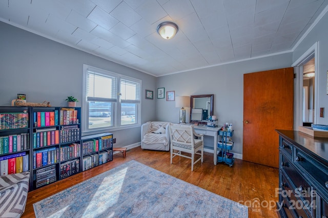 home office featuring hardwood / wood-style flooring and crown molding