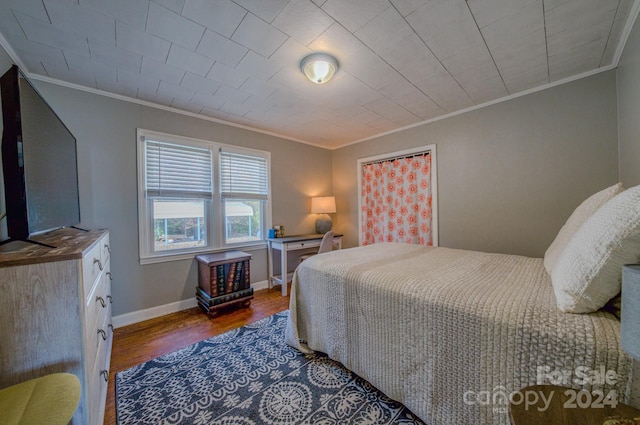 bedroom featuring wood-type flooring and ornamental molding