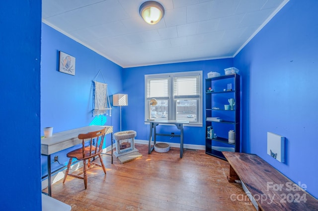 office with ornamental molding and hardwood / wood-style flooring