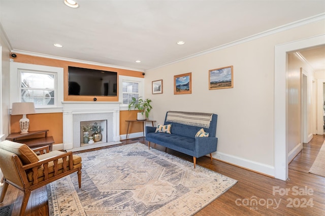 living room with hardwood / wood-style floors, a wealth of natural light, and crown molding